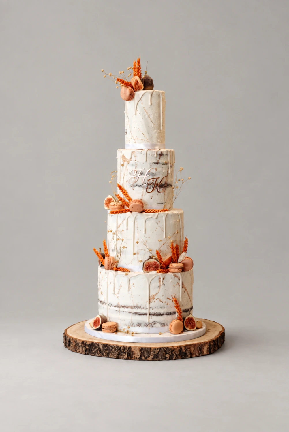 Four-tier semi-naked cake with autumn-coloured decorations and sliced figs on a wooden stand