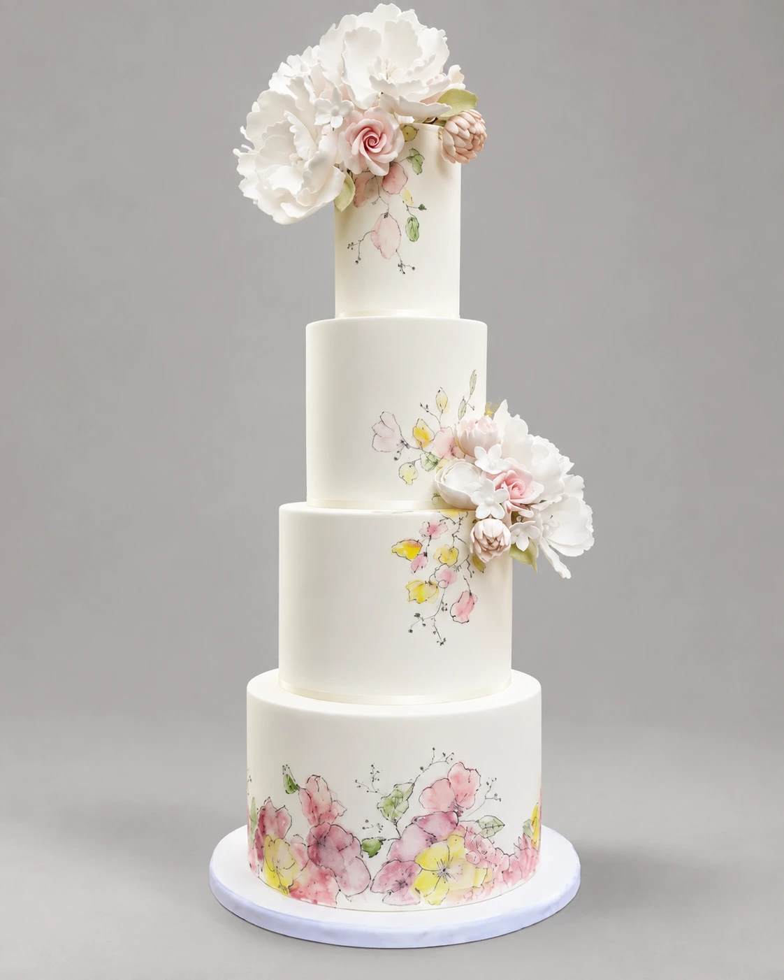 Four-tier ivory cake with painted pastel flowers and clusters of white and blush sugar flowers