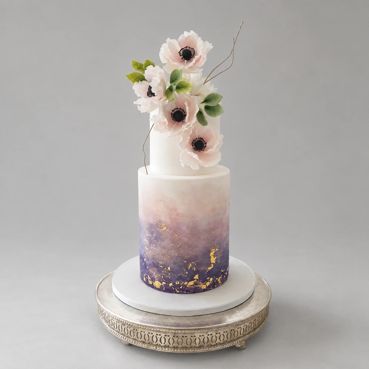 Two-tier ivory and purple watercolour cake with gold flecks and white anemone flowers
