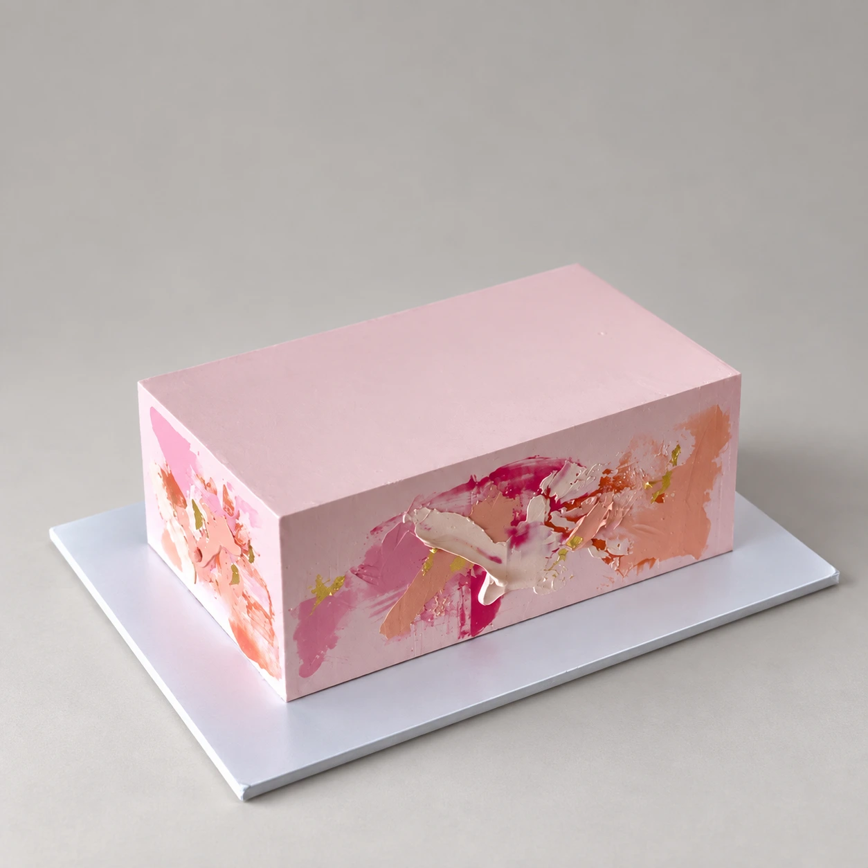 Single-tier rectangular pink cake with peach, ivory and fuchsia palette knife flowers